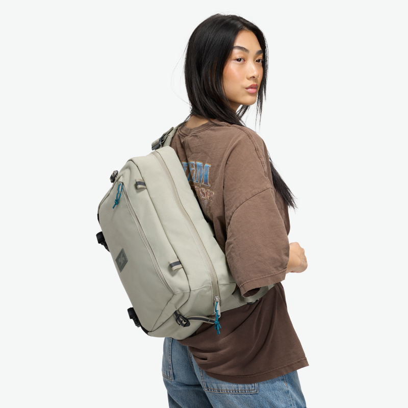 Chrome Cadet Max sling bag with seatbelt buckle closure in Sage